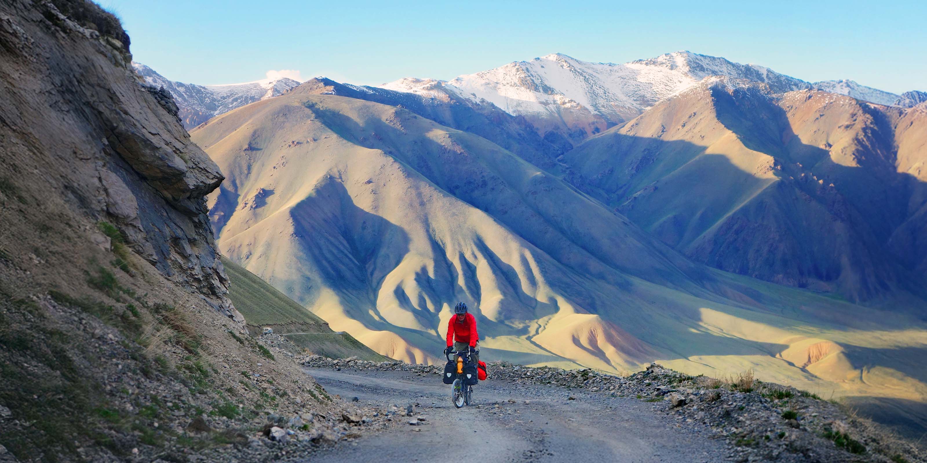 Cyclist Tobias crossing mountains in Kyrgyzstan on a Moulton bike in 2015.